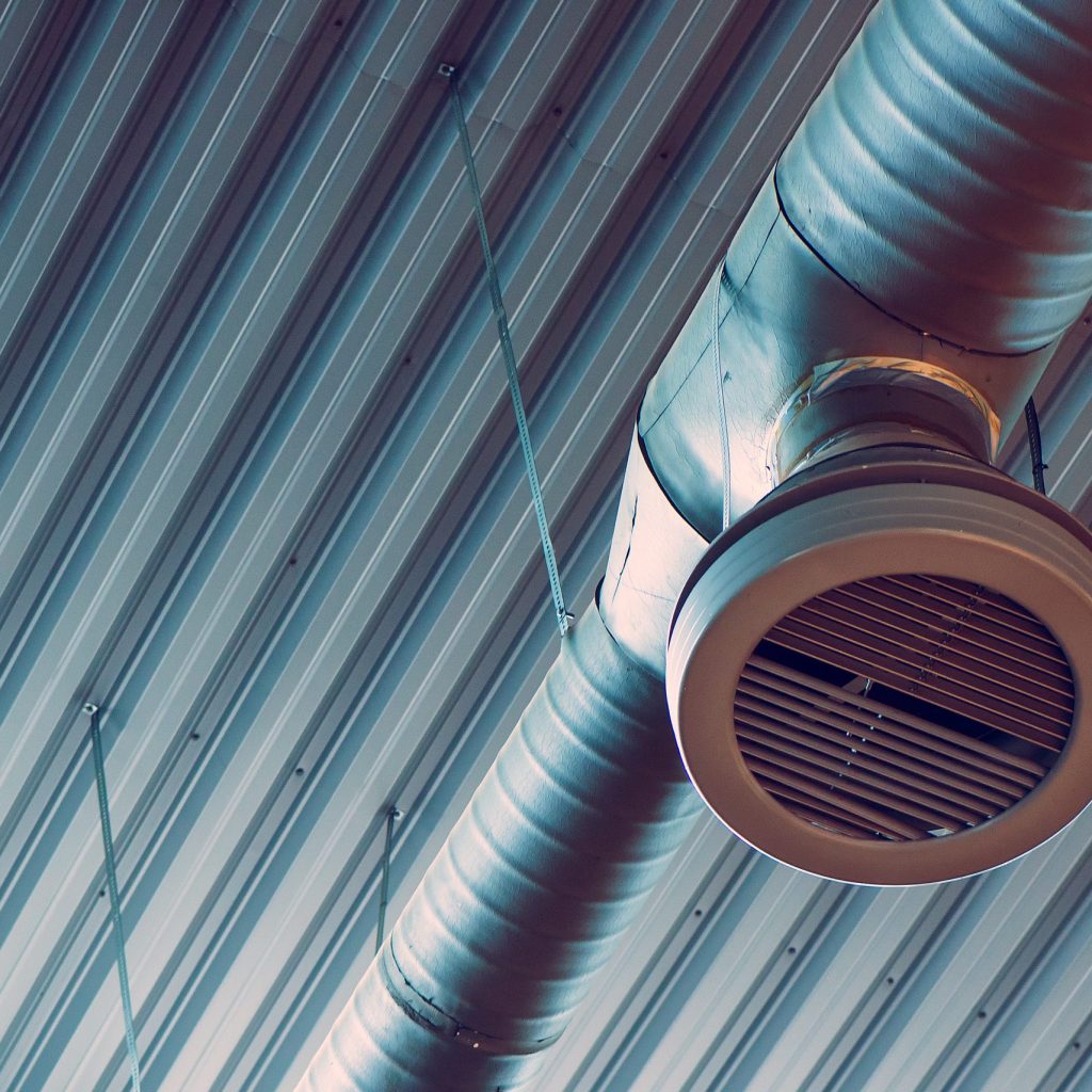 Industrial warehouse air ventilation system pipe on the ceiling